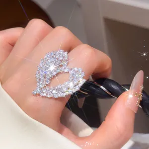 Close-up of sparkling openwork heart ring pavé-set with brilliant cubic zirconia