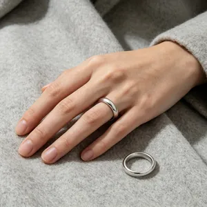 Detail view of 4mm polished 304 stainless steel band ring on soft wool fabric