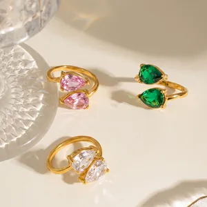 Detail view of three stainless steel rings with colorful pear-shaped cubic zirconia.