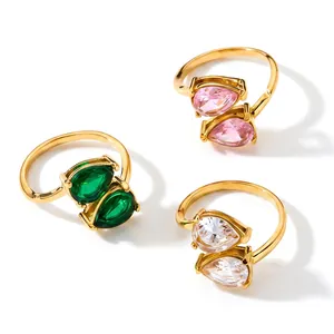 Detailed view of three gold stainless steel rings with pear-cut colorful zircons.