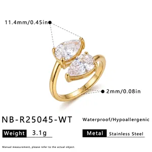 Detailed view of a gold stainless steel ring with dual pear-shaped cubic zirconia