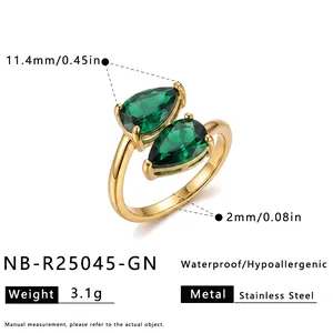 Stainless steel gold ring with two green pear-shaped zirconia stones showing dimensions