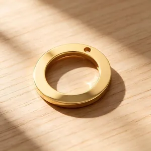 Close-up of a minimalist gold stainless steel circular ring pendant for DIY jewelry