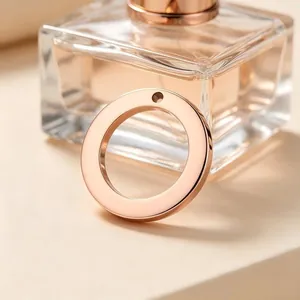 Close-up view of a rose gold stainless steel circular charm with high-polish finish.