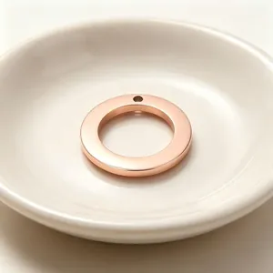 Close-up of rose gold stainless steel round pendant for DIY jewelry making.