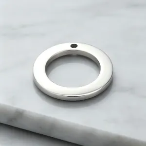Macro detail of a glossy stainless steel circular ring pendant for DIY jewelry making