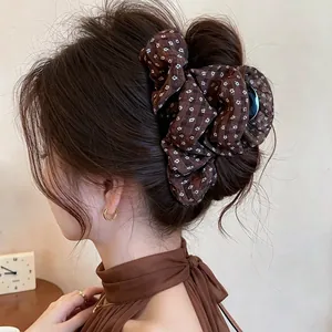 Elegant brown floral fabric hair scrunchie styled in a high bun for Korean fashion.