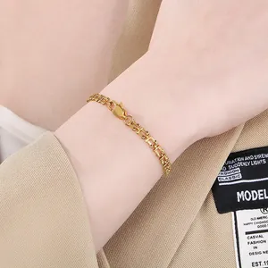 Elegant gold stainless steel music note chain bracelet for women shown on a model's wrist