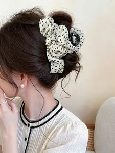Elegant Korean style floral fabric hair claw clip shown in a stylish bun updo hairstyle