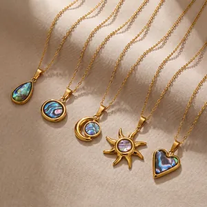 Vue détaillée de cinq colliers en acier inoxydable avec pendentifs en nacre de diverses formes.