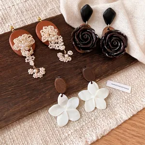 Vintage ethnic style earring set featuring pearls, black roses, and white flowers