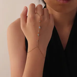 Detailed close-up view of minimalist gold finger bracelet with elegant white zircons