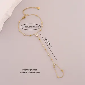 Detailed view of minimalist stainless steel finger bracelet with white stones and size info