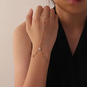 Detail view of a gold minimalist hand harness with elegant white zirconia stones