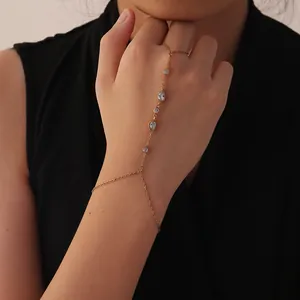 Elegant gold stainless steel finger bracelet featuring teardrop cubic zirconia stones