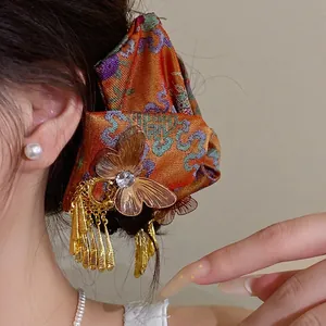 Antike Ethno-Schmetterlings-Haarklammer mit goldenen Quasten und Kristall-Details