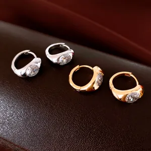 Detail of gold and silver plated hoop earrings with sparkling round cubic zirconia