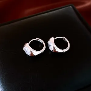 Detail showing silver 18K gold plated hoop earrings with inlaid oval zircon stones