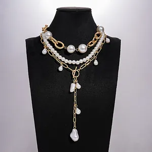Gelaagde vintage parelketting met elegante gouden kettingen en parel OT-sluiting