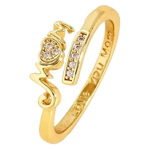 Close-up of gold-plated copper adjustable heart ring with 'Mom' and cubic zirconia