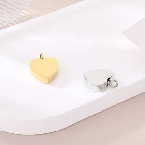 Detailed macro view of polished gold and silver heart-shaped stainless steel pendants