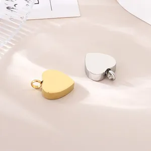 Detailed close-up view of minimalist gold and silver heart-shaped stainless steel pendants.