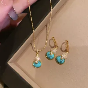 Detail of 18k gold plated turquoise gourd necklace and earrings set with zirconia