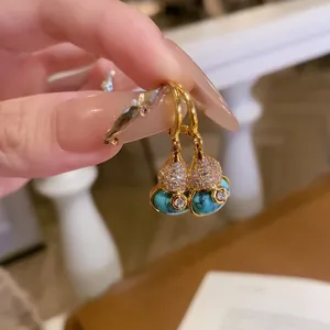 Detailed close-up of 18k gold-plated Wulu gourd pendant with turquoise and zircon stones