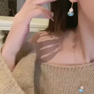 Close-up of 18k gold plated gourd necklace and earring set with turquoise