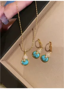 Detailed view of 18k gold plated turquoise gourd pendant necklace and earring set