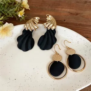 Pendientes vintage extragrandes retorcidos irregulares oro y negro mate en plato