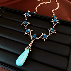Macro-opname van een vintage ketting met blauwe kristallen en turquoise druppelhanger