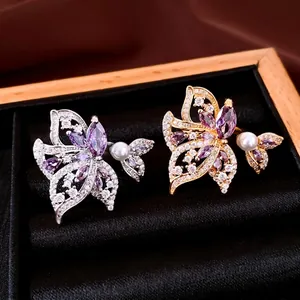 Anillos alas de mariposa bañados en oro 18k con circonita púrpura y perlas