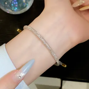 Gedetailleerd overzicht van glinsterende zilveren mesh armband met gouden accent