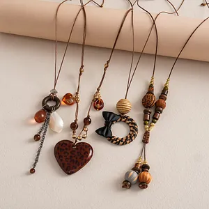 Detailed shot of assorted vintage-style necklaces with leopard hearts and woven charms.