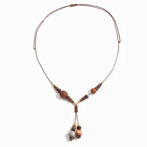 Vintage bohemian handmade beaded necklace featuring wood and acrylic beads on brown cord