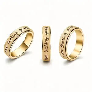 Gold stainless steel rotatable ring with motivational keep fucking going inscription.