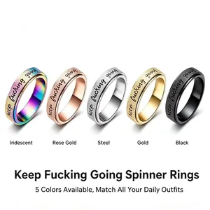 Stainless steel spinner rings in five colors with engraved keep fucking going text details