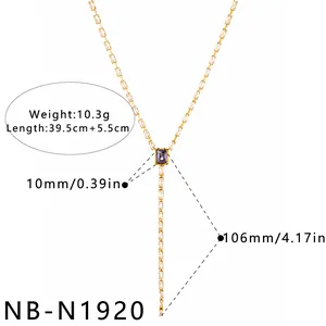 Macro view of gold Y-shaped necklace with purple and clear zircon stones for women.