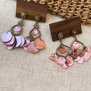 Vintage bronze drop earrings featuring pink rhinestones and iridescent shell tassel discs