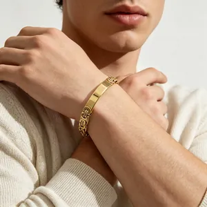 Close-up of a men's gold-toned Byzantine titanium steel bracelet with engravable bar