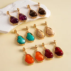 Group of vintage irregular resin earrings with gold metal frames in various colors