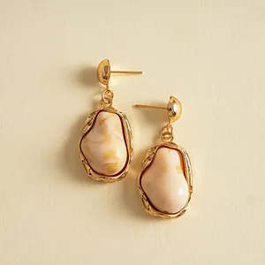 Detailed view of vintage irregular resin earrings with gold-toned metal accents.