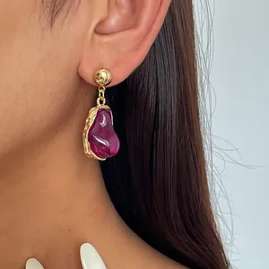 Detailed view of retro irregular magenta resin earrings featuring a gold metallic frame.