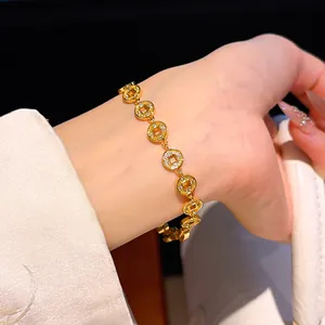 Detailaufnahme eines 24k vergoldeten Armbands mit Zirkonia-Münzen am Handgelenk