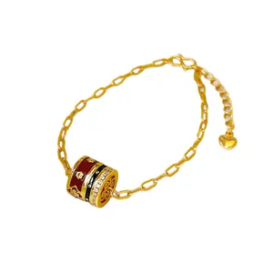 24K gold-plated bracelet with red enamel cylindrical charm and sparkling zircons