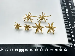 Detail view of three pairs of 18K gold plated stainless steel firework and flower stud earrings