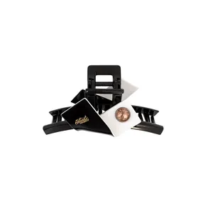 Elegant black and white geometric hair claw clip with sparkling rhinestone detail