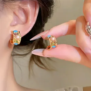 Vintage style gold hoop earrings with pearl and colorful zircon for a retro elegant look.