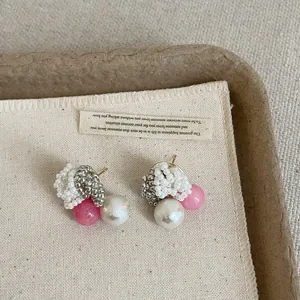 Detailed view of Korean style beaded pearl stud earrings with pink and white beads